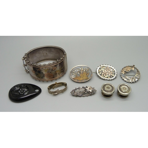 990 - A Victorian silver bangle, four silver and white metal brooches, one lacking pin, a jet pendant, etc... 