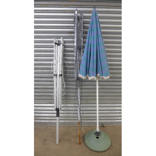 2240 - 2 Rotary clothing airers and parasol umbrella with base