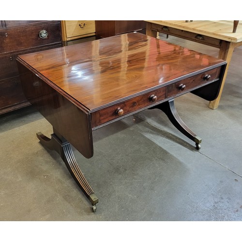 23C - A George IV mahogany double sided four drawer drop-leaf sofa table