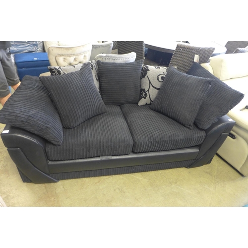 1651 - A charcoal jumbo corduroy and snake skin effect two seater sofa