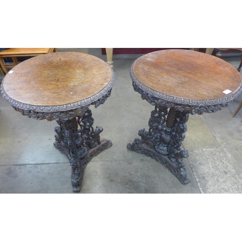 1 - A pair of Burmese carved hardwood circular lamp tables