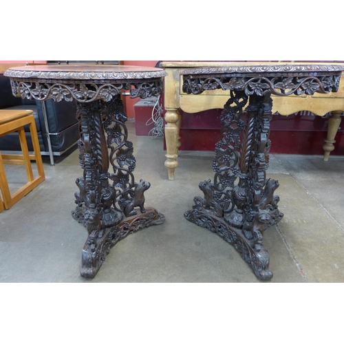 1 - A pair of Burmese carved hardwood circular lamp tables