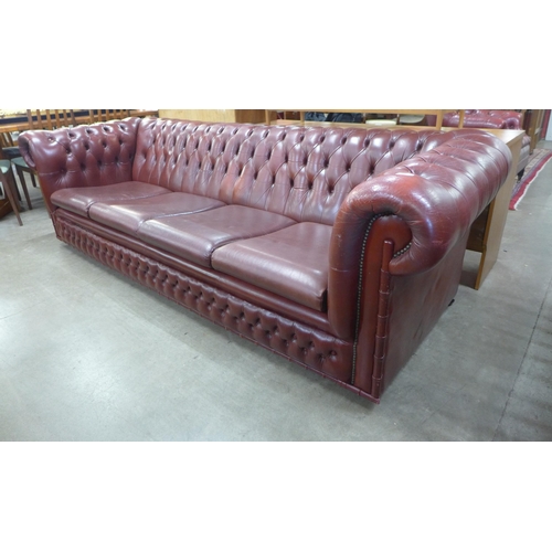 104 - An oxblood red leather Chesterfield settee