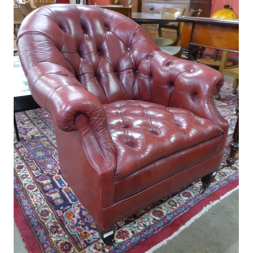 11 - A Regency style red buttoned leather library chair