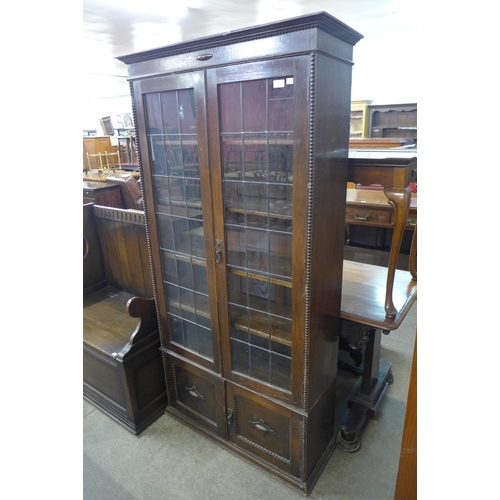 117 - An early 20th Century oak four door bookcase