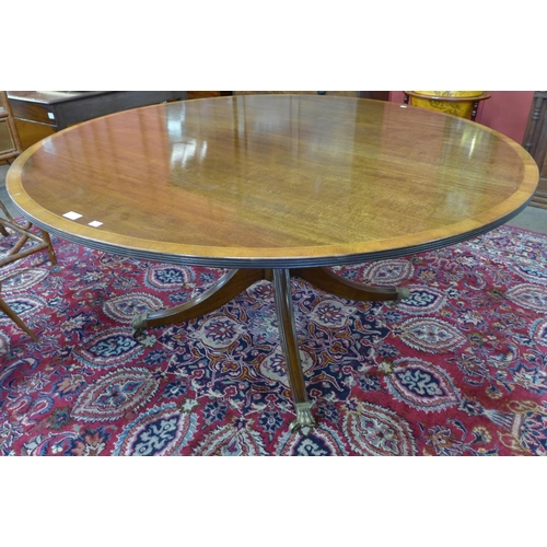 12 - A Regency style inlaid mahogany circular dining table