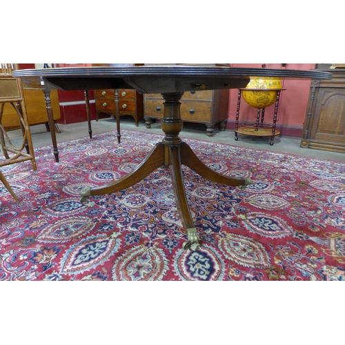 12 - A Regency style inlaid mahogany circular dining table