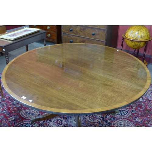 12 - A Regency style inlaid mahogany circular dining table