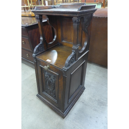 124 - A Victorian carved oak purdonium, made by Garrett & Sons, Warrington