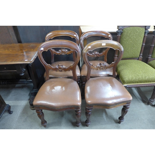 128 - A set of four Victorian carved mahogany balloon back dining chairs