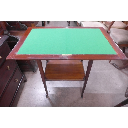 131 - An Edward VII mahogany fold over games table