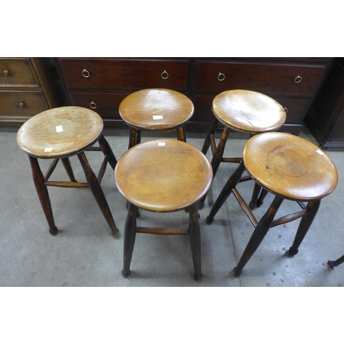 136 - A set of five Victorian elm and fruitwood kitchen stools