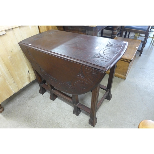 139 - A carved oak gateleg table