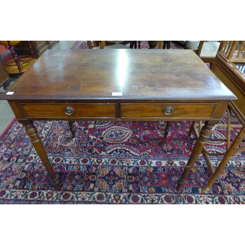 14 - A Victorian mahogany two drawer writing table