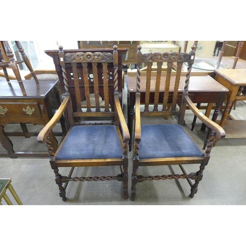 140 - A pair of early 20th Century oak barleytwist elbow chairs