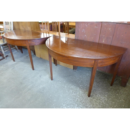 155 - A pair of George IV mahogany demi-lune console tables