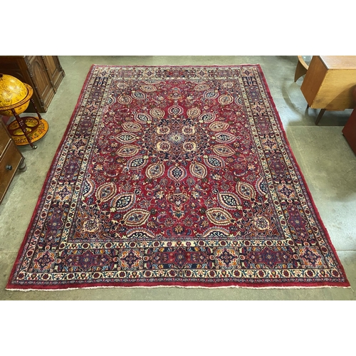 16 - A large Persian red ground rug