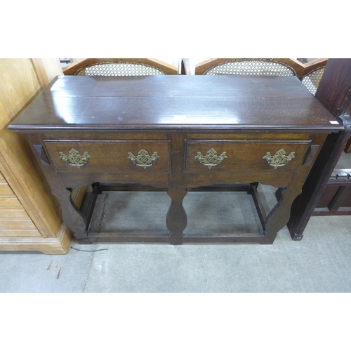 167 - A small George III style oak two drawer dresser