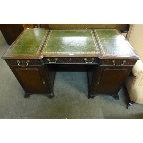 182 - A Victorian Chipendale Revival carved mahogany and green leather topped library desk