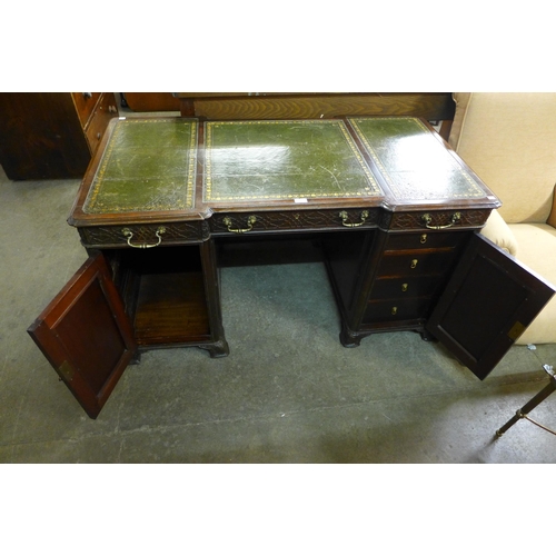 182 - A Victorian Chipendale Revival carved mahogany and green leather topped library desk