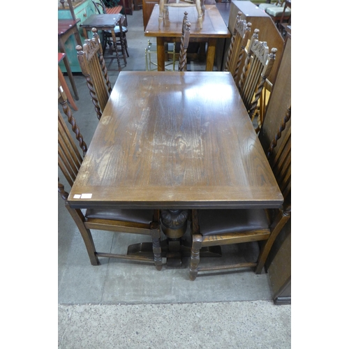 192 - A 17th Century style carved oak refectory table and six barleytwist chairs