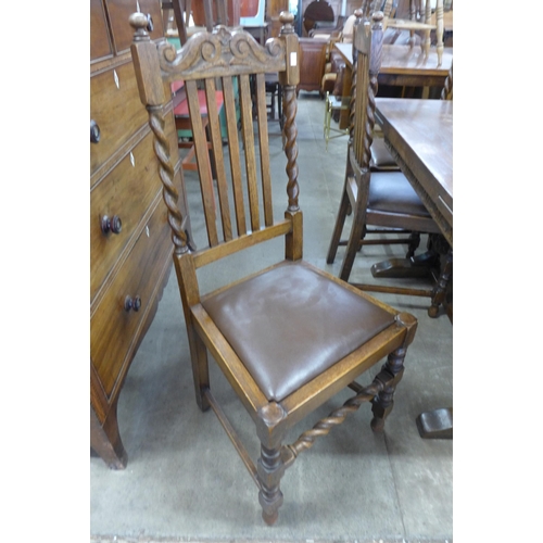 192 - A 17th Century style carved oak refectory table and six barleytwist chairs