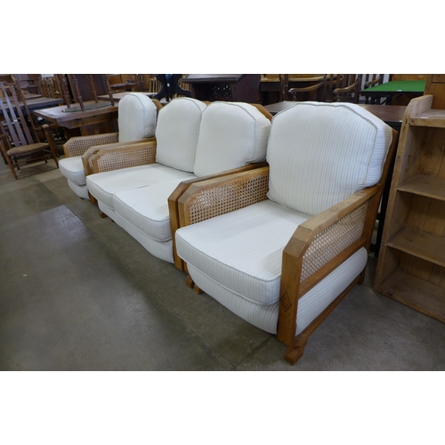 193 - An Art Deco oak bergere three piece suite