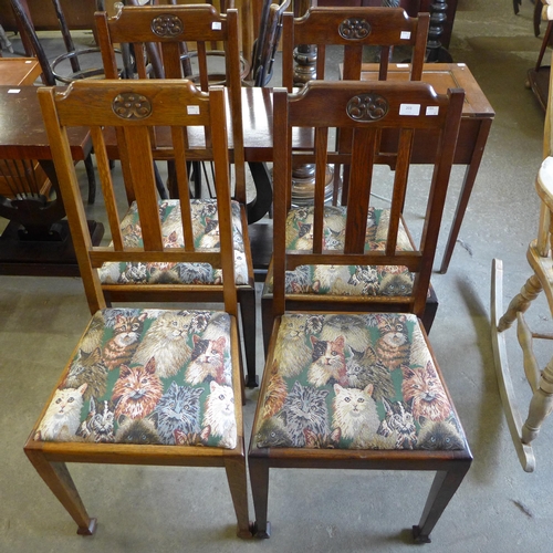 203 - A set of four Arts and Crafts oak dining chairs