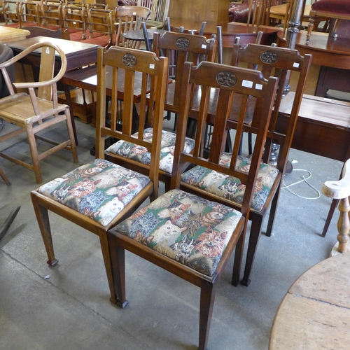 203 - A set of four Arts and Crafts oak dining chairs