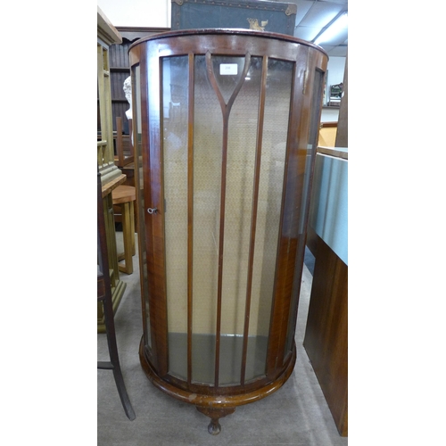 208 - A walnut bow front display cabinet