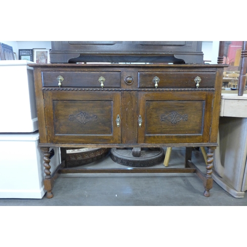 212 - An oak blanket box and an oak barleytwist sideboard