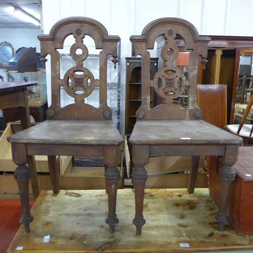 218 - A pair Victorian Gothic Revival Thomas Simpson mahogany hall chairs