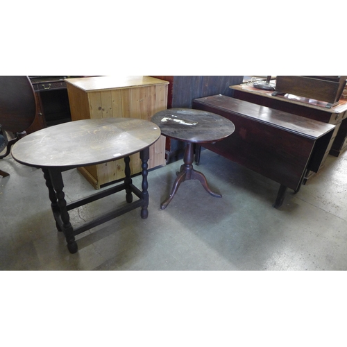 223 - A George III mahogany drop leaf table, an oak tripod table and an oak oval occasional table