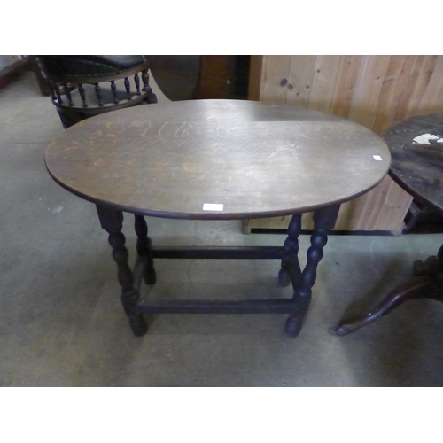 223 - A George III mahogany drop leaf table, an oak tripod table and an oak oval occasional table