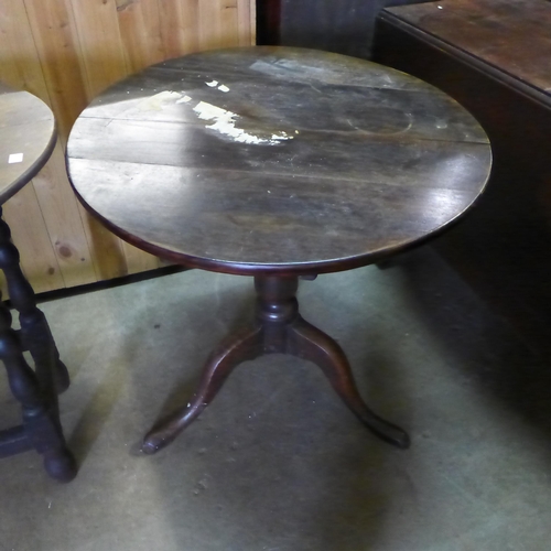 223 - A George III mahogany drop leaf table, an oak tripod table and an oak oval occasional table