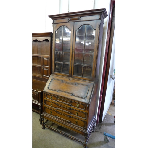 228 - A 17th Century style oak geometric moulded barleytwist bureau bookcase