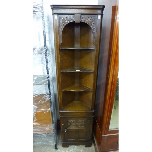 231 - A 17th Century style carved oak freestanding corner cabinet