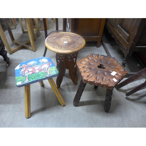 239 - A small painted wooden milking stool and three other stools