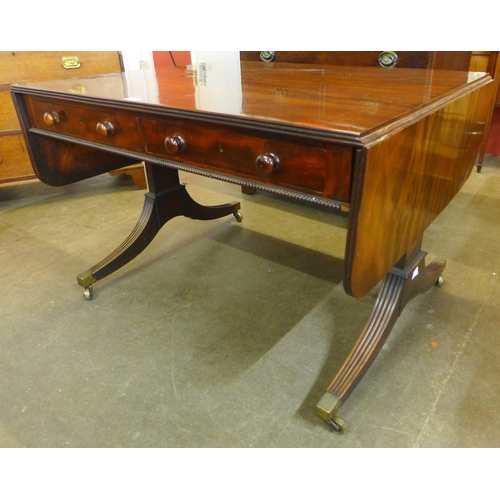 23C - A George IV mahogany double sided four drawer drop-leaf sofa table