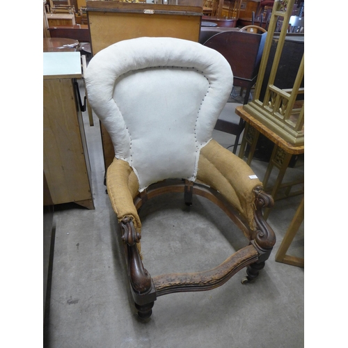 241 - A Victorian carved oak spoonback armchair frame