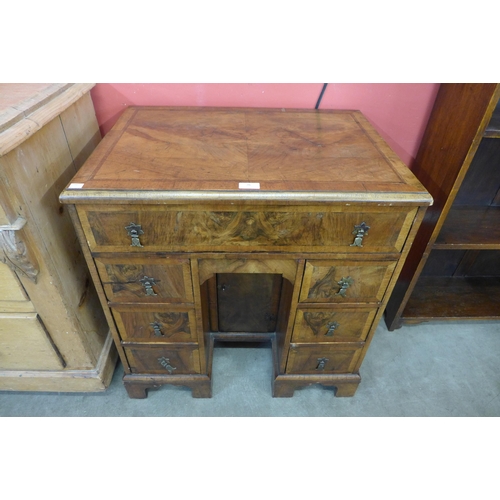 26 - A George I style walnut kneehole desk