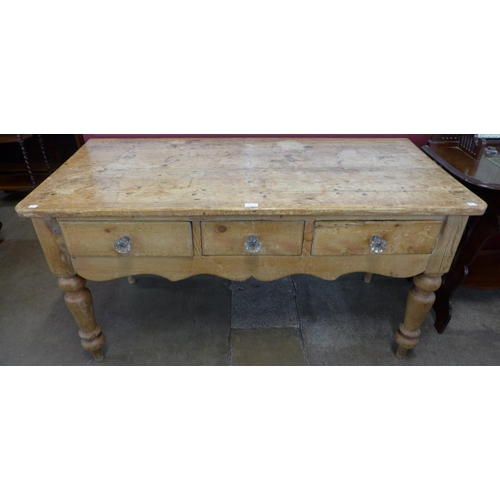 3 - A Victorian waxed pine three drawer serving table