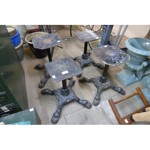 310 - A set of four cast iron stool bases