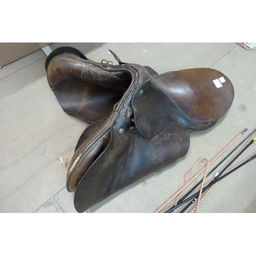 317 - A leather horse saddle and assorted riding crops