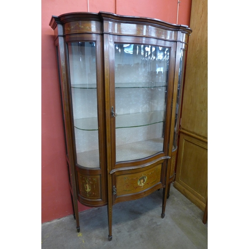 35 - An Edward VII inlaid and painted mahogany Sheraton Revival serpentine display cabinet