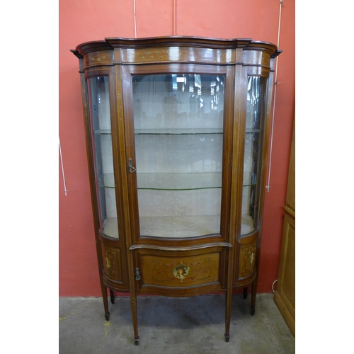 35 - An Edward VII inlaid and painted mahogany Sheraton Revival serpentine display cabinet