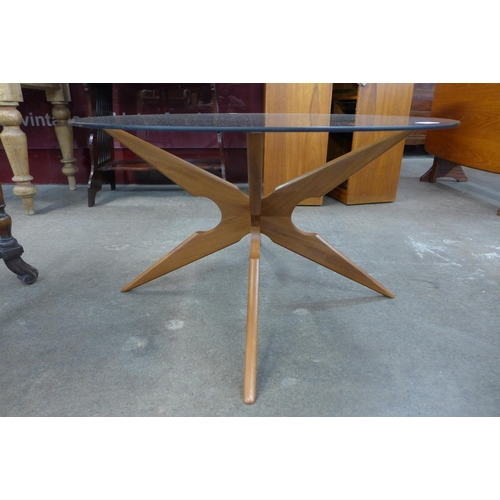 38 - A Danish Sika Mobler teak and glass topped circular spider leg coffee table, designed by Vladimir Ka... 