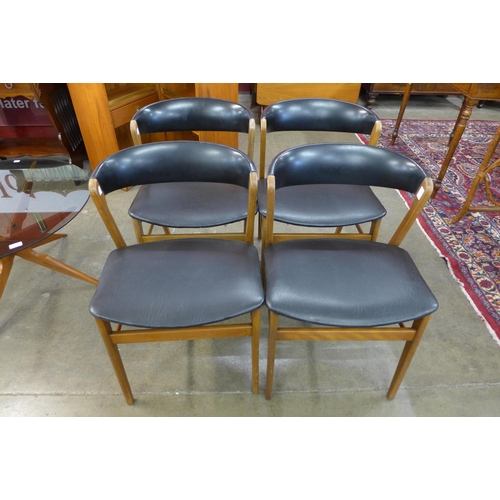 40 - A set of four Danish beech and black vinyl chairs, manner of Kai Kristiansen