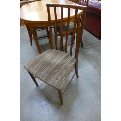 50 - A McIntosh teak extending dining table and four chairs