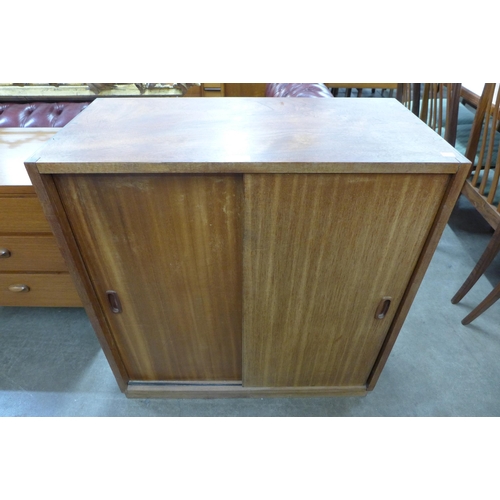 54 - A teak two door cupboard